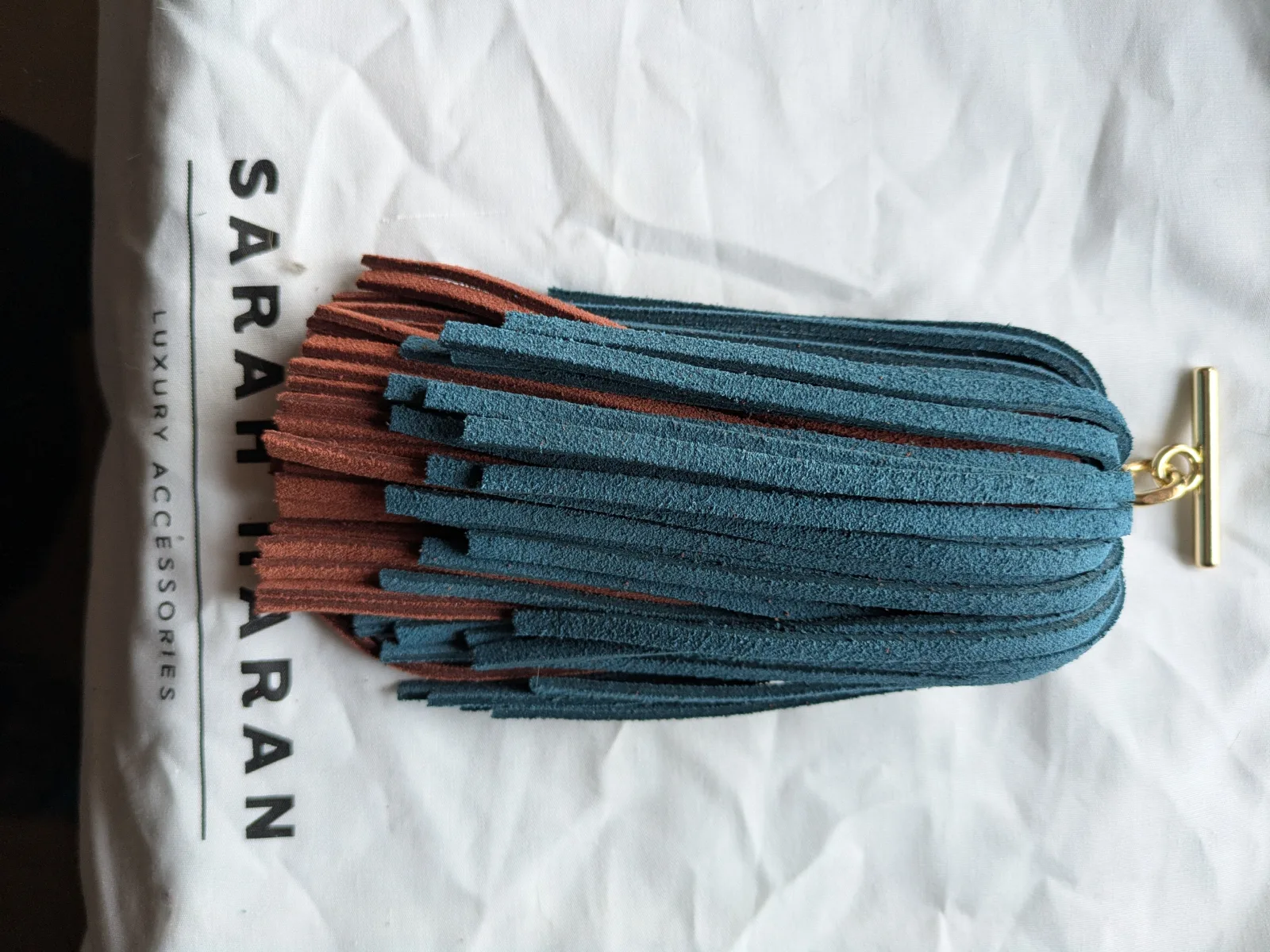 Brand new unused Petrol and Rust suede double pompom tassel gold hardware 