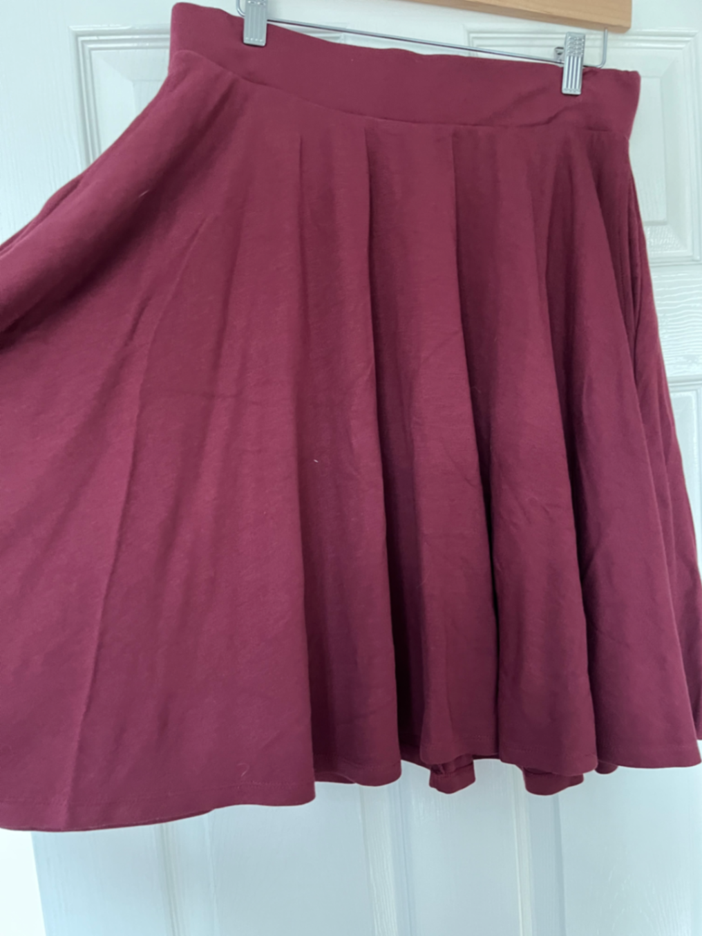 Burgundy knee length flare skirt.
