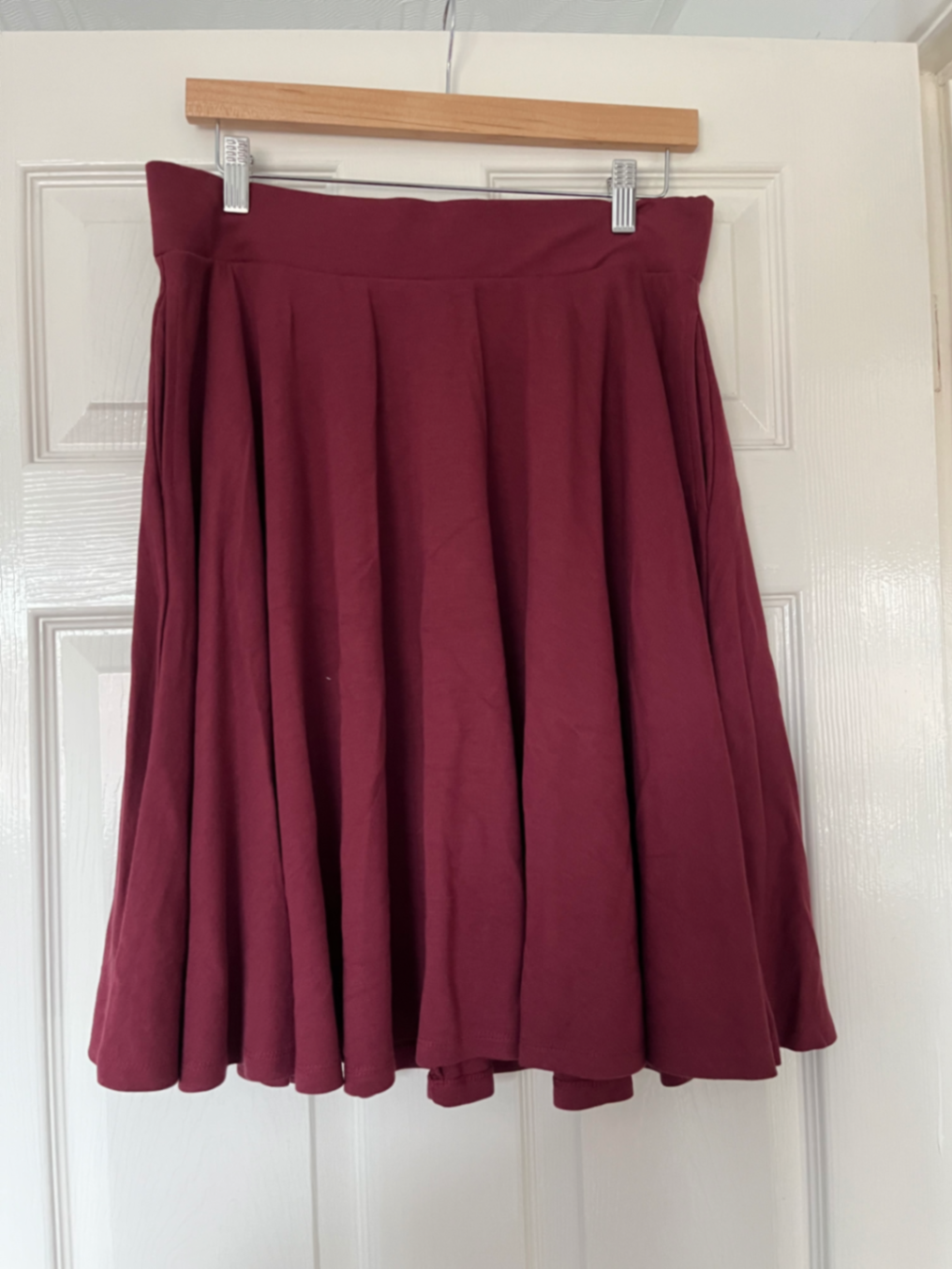 Burgundy knee length flare skirt.