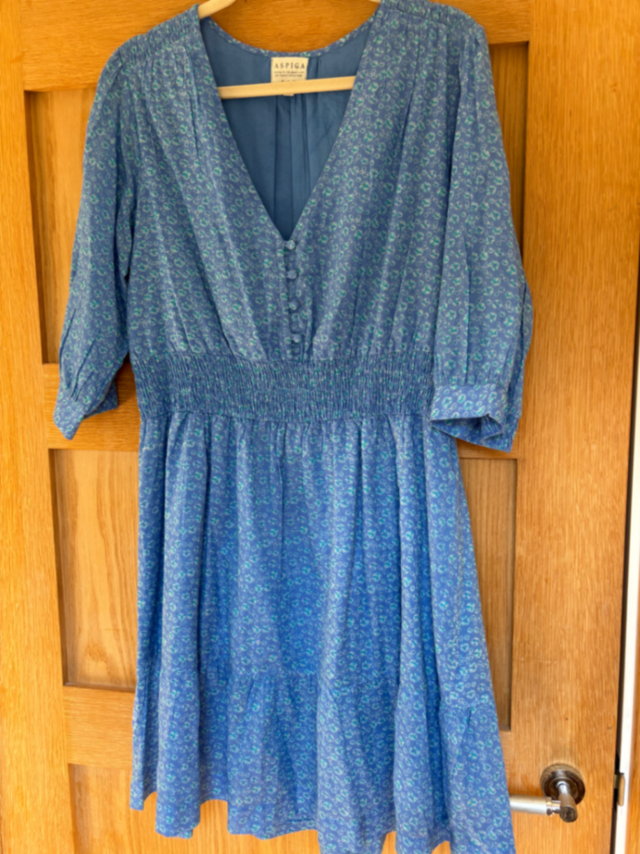 Short cotton voile dress. Very pretty print. Lined skirt and shirted waistline. Knee length.