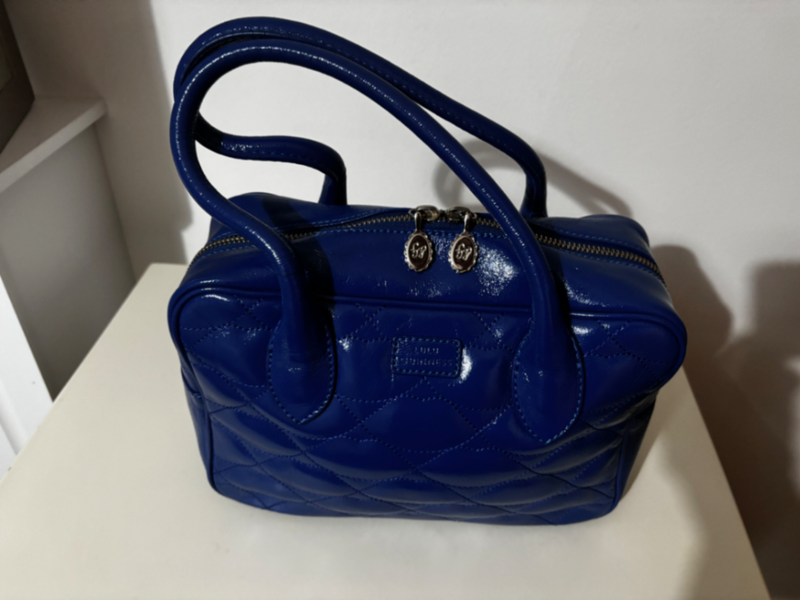 Small bright blue patent leather padded lips bowling bag