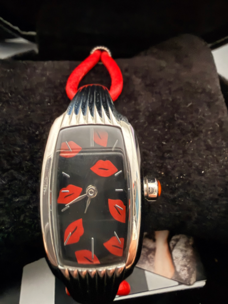 Red strap watch with lips on face 